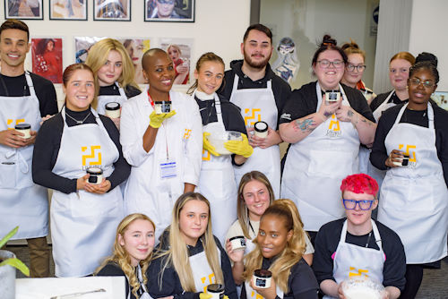 Students showing their products from their cosmetic formulation training course