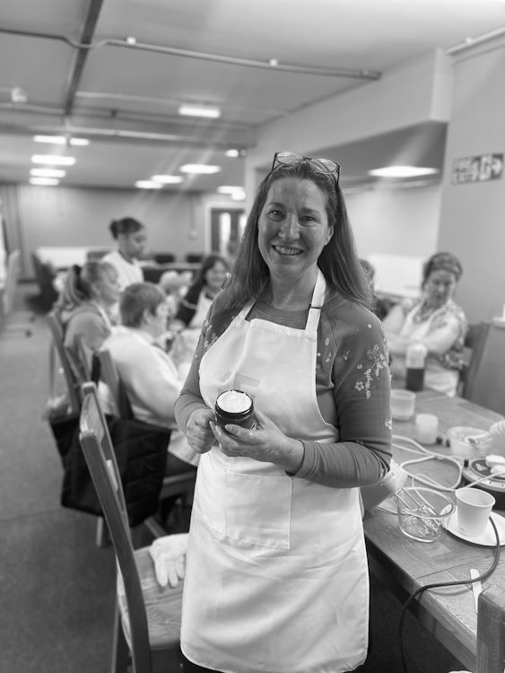 Student showing their finished cream after a cosmetic product development course.