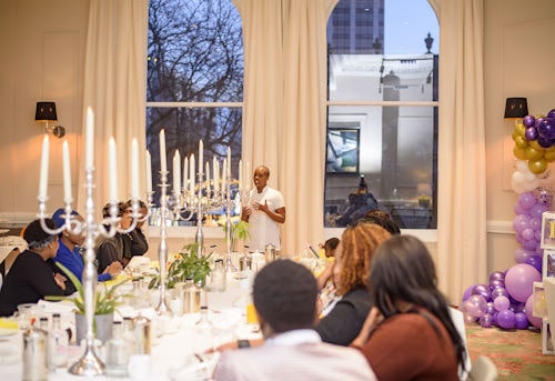 Neo speaking to a group of students who are learning to formulate cosmetics