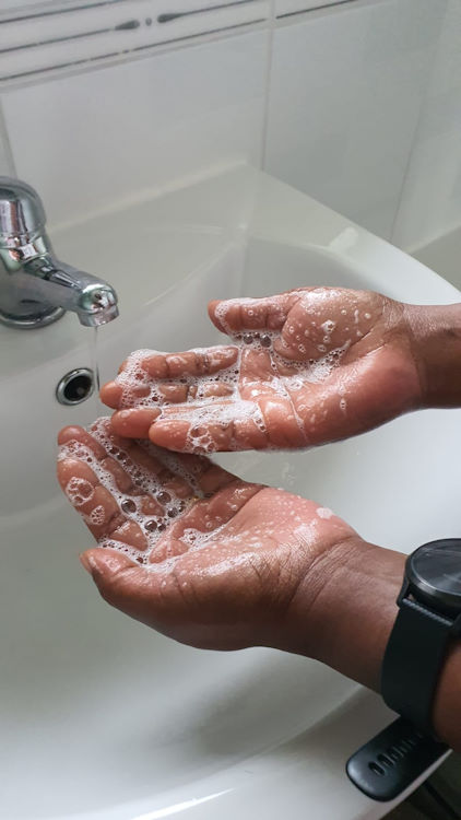 A person washing their hands.