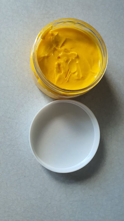 Jar of yellow cream created by a comsetic formulation course student